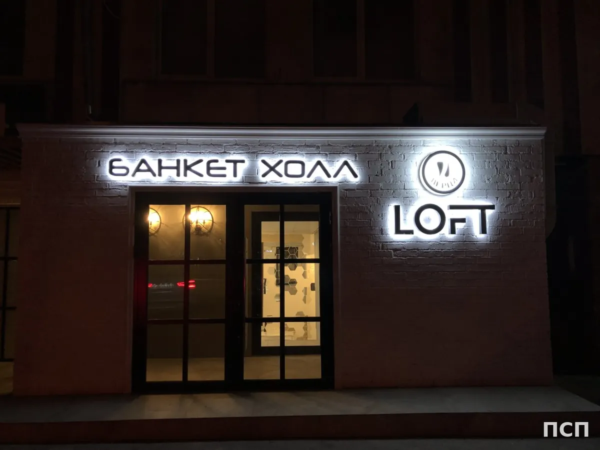 Вывеска «Банкет холл Loft» с контражурной подсветкой вечером